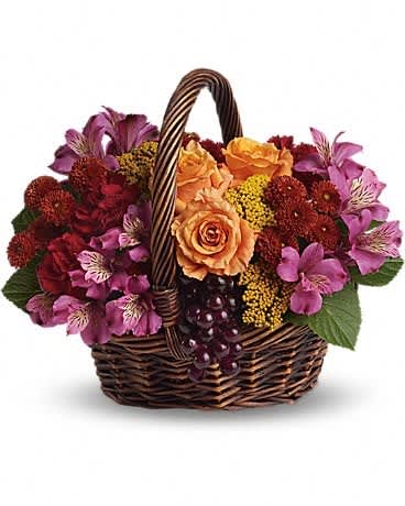 Sending Joy - Know anyone who would really appreciate a basketful of joy right now? Send love and flowers with this beautiful array of fantastic fall flowers. The basket overflows with orange roses and spray roses, maroon carnations, purple alstroemeria, burgundy button spray chrysanthemums, yarrow and even a bunch of grapes (not real, of course)!