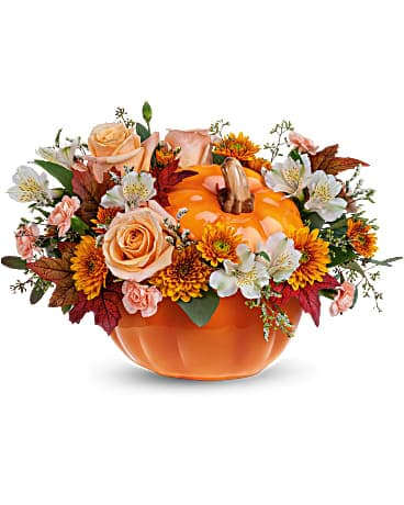 Teleflora's Hello Pumpkin Bouquet - Welcome Fall into your home with this warm and cozy, Hello Pumpkin arrangement. The autumnal mix will add a sophisticated touch with crÃ¨me roses combined with the warm hues of bronze chrysanthemums and peach mini carnations! This charming arrangement features crÃ¨me roses, white alstroemerias, peach miniature carnations, bronze cushion spray chrysanthemums, and seeded eucalyptus. Delivered in the Hauntingly Pretty Pumpkin.