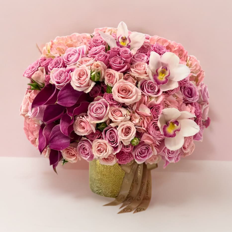 Pink Passion - A blend of pink &amp; hot pink roses topped off with orchids and calla lilies.