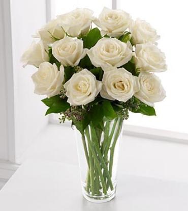 Long Stem White Rose Bouquet Long Stem White Rose Bouquet - The beauty of white roses is unchallenged. Representing innocence, their versatility makes them a favorite gift to offer congratulations for graduation, engagements, bridal showers, new baby, or even a gift of sympathy. This white rose bouquet is accented with seeded eucalyptus and arranged in a simple glass vase. Item # N20-4308