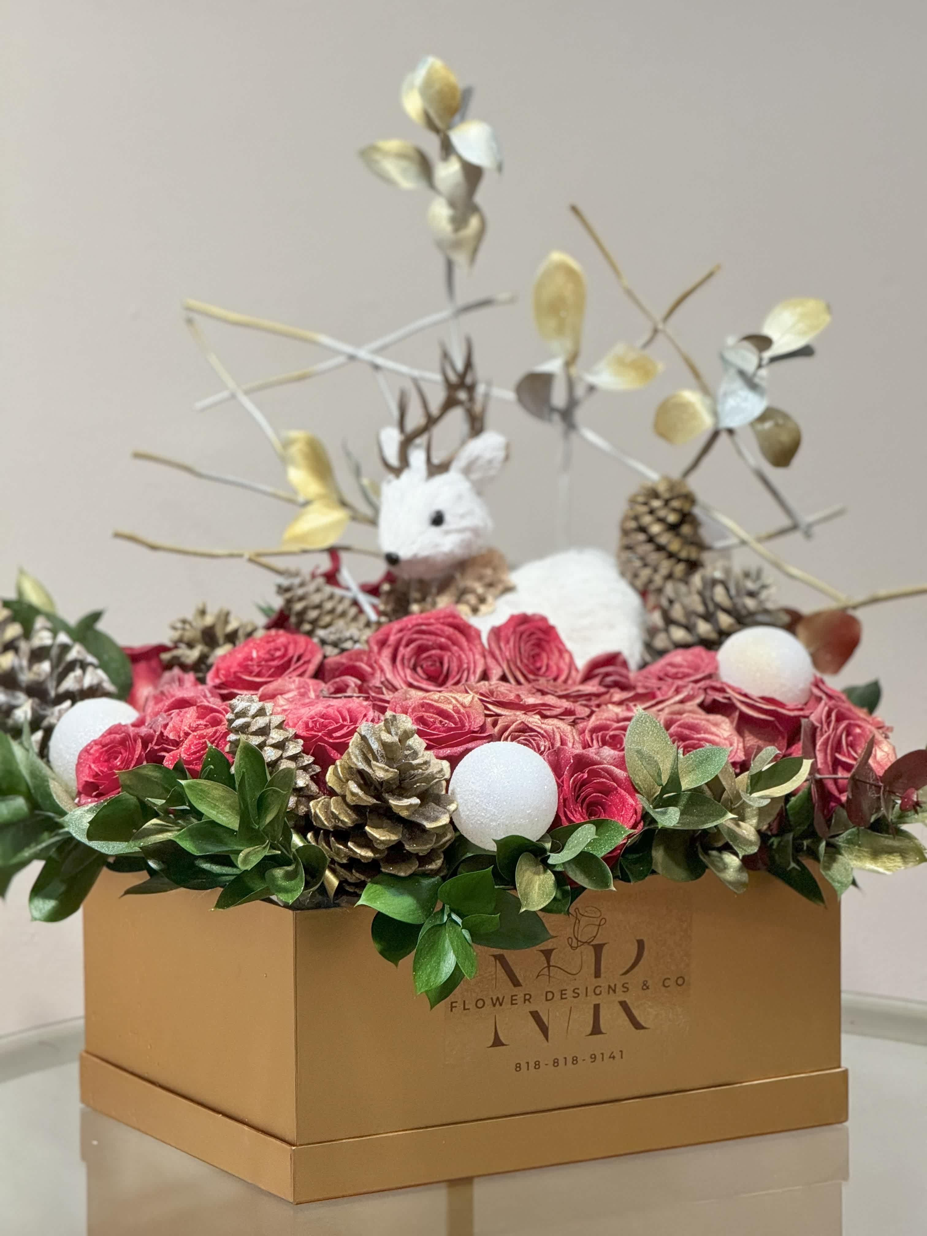 Winter Wonderland - A golden box full of red roses, pine cones and greenery, decorated with white ornaments. This is a great Christmas or just a winter gift. Can also be used to complete holiday decor in any setting!