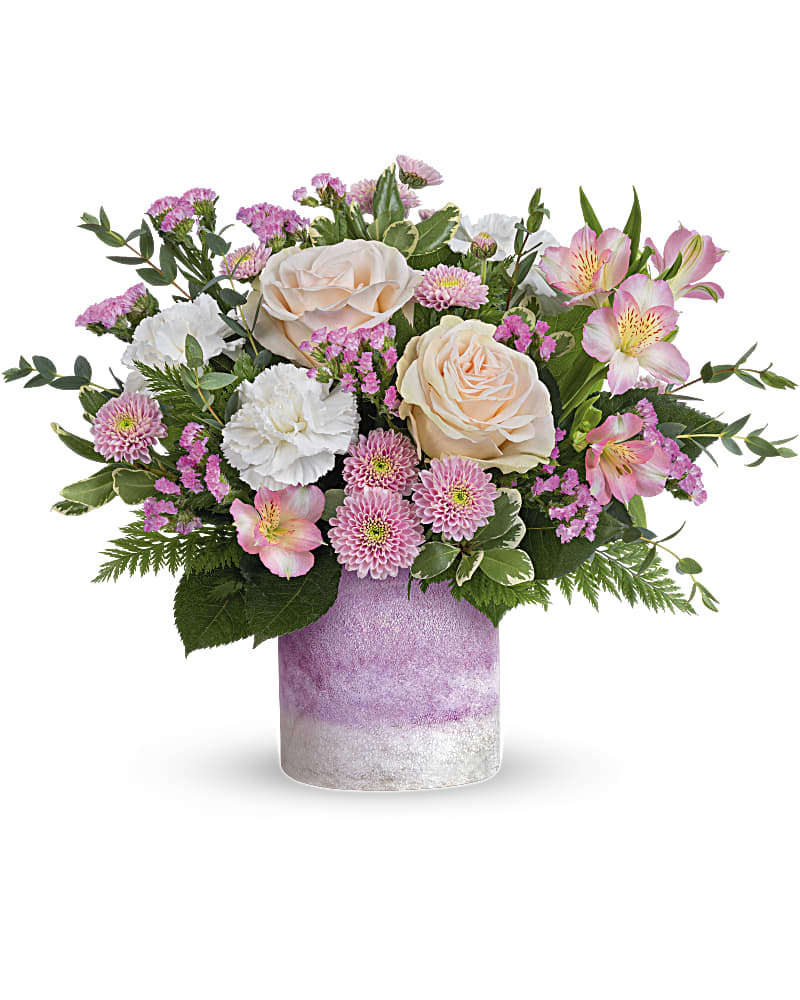 In A Blush Bouquet  - A pretty pink-me-up for any occasion, these blushing blooms in an art glass keepsake vase are sure to brighten their day  Blush roses, pink alstroemeria, white carnations, pink button spray chrysanthemums and raspberry sinuata statice and arranged with leatherleaf fern, variegated pittosporum and parvifolia eucalyptus