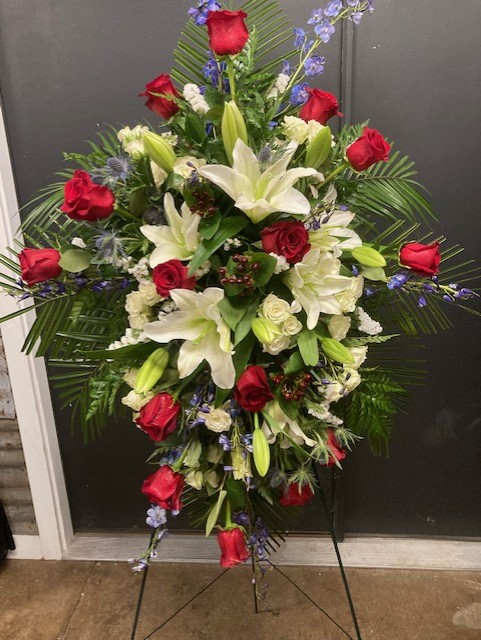 Patriotic Peace - This spray has a combination of red, white and blue to honor someone who is patriotic or has served in the military. Ribbon can be added for an additional fee. 