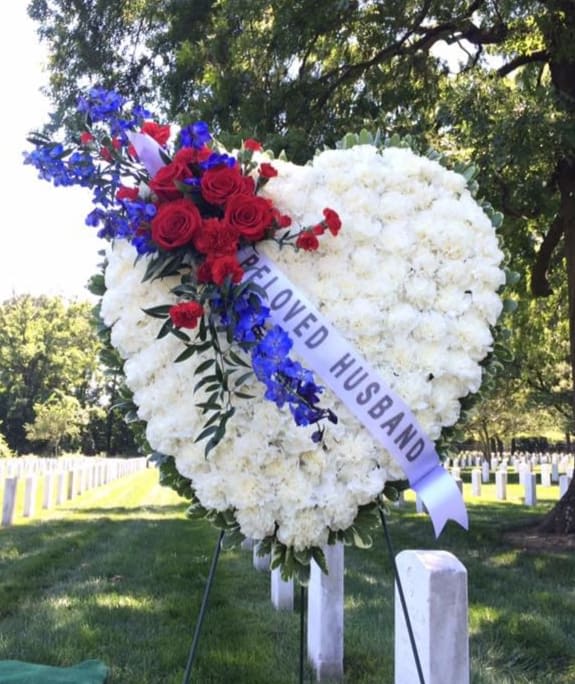 PATRIOTS HEART ON EASEL WITH PRINTED SASH  - PATRIOTS HEART ON EASEL WITH PRINTED SASH  BY TWIN TOWERS FLORIST. CUSTOM EXCLUSIVE PAVÉ HEART STANDING SPRAY FOR ARLINGTON NATIONAL CEMETERY FUNERAL FLOWERS FOR FUNERAL SERVICES, MEMORIAL TRIBUTES, AND WREATH LAYING CEREMONIES AT THE TOMB OF THE UNKNOWN SOLDIER.   ONE OPTIONAL PRINTED SASH IS INCLUDED IN THE STANDARD PRICE.