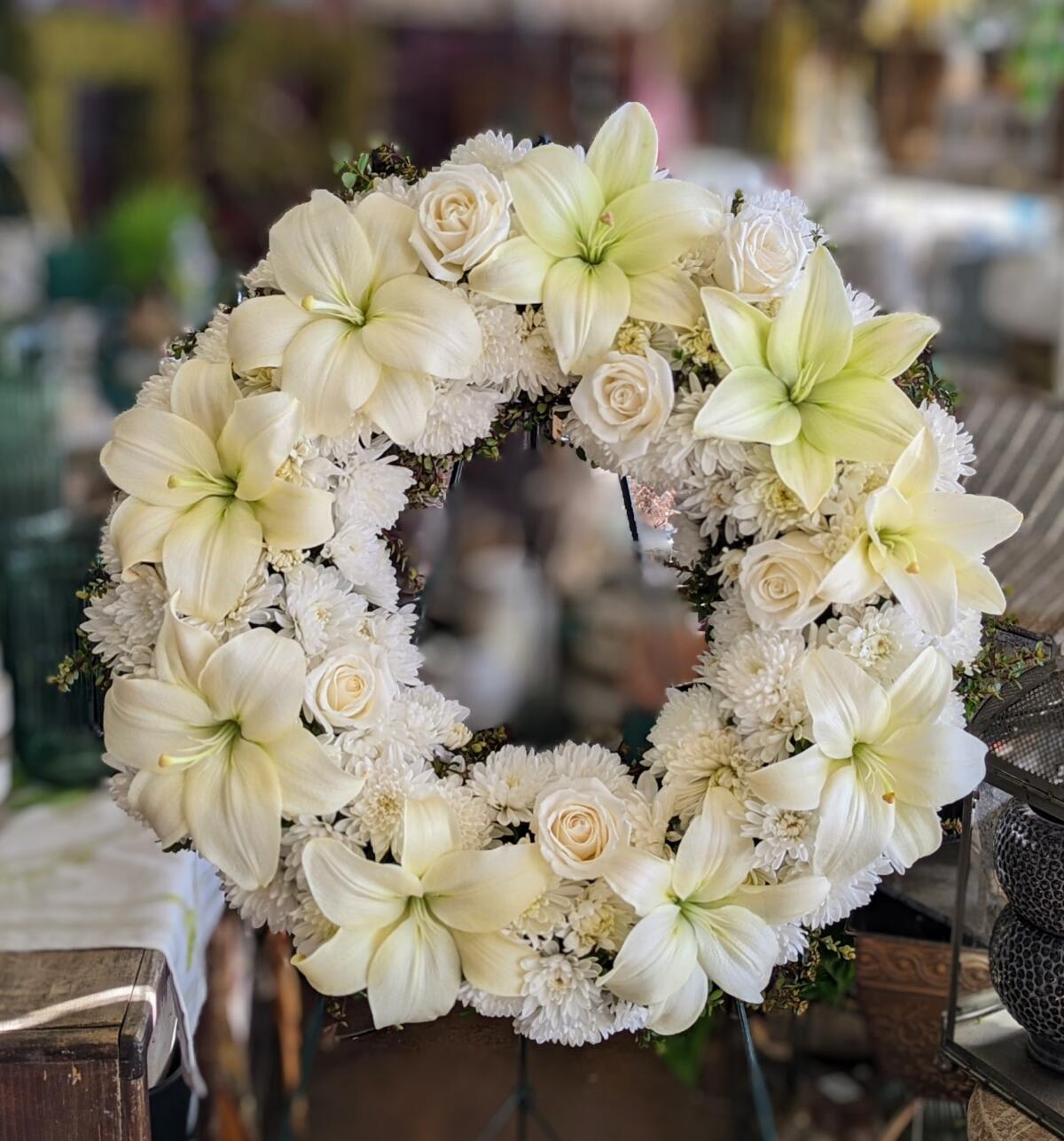 White Serenity Wreath - All white flowers that include lilies, chrysanthemums, and roses.