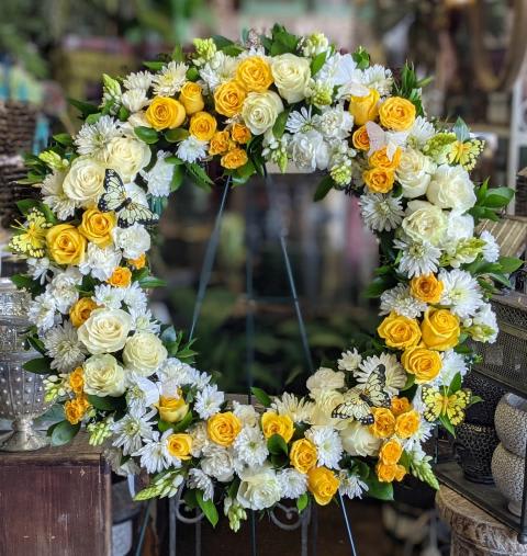 Yellow and White Serenity Wreath - A large 24 inch yellow and white wreath that features roses, mums, and carnations.