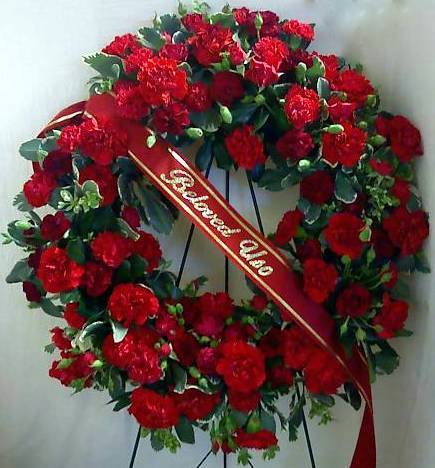 Ring of Love - A lush wreath consisting of carnations, mini carnations, roses, and mixed greenery.