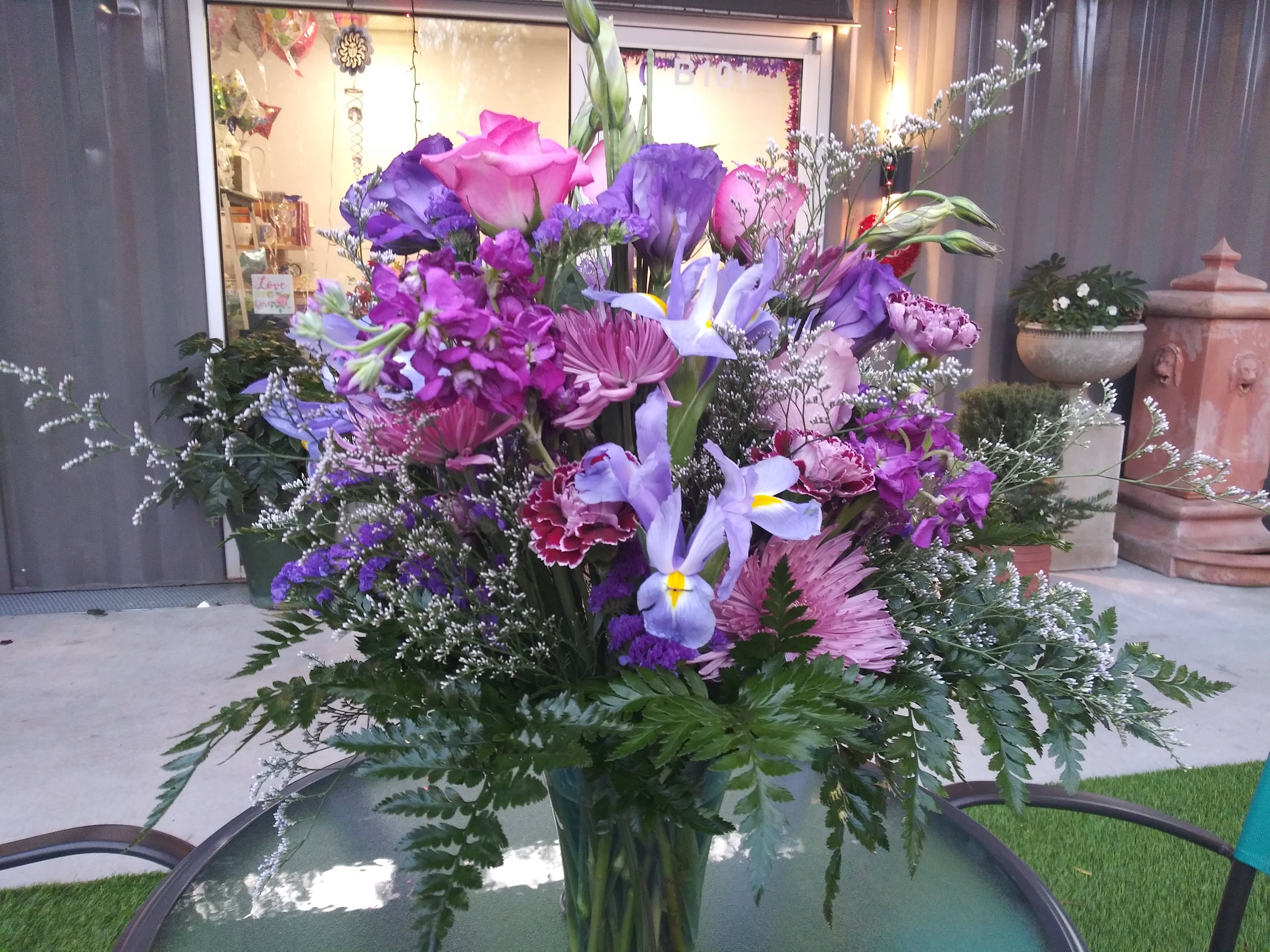 Nile Valley - An ode to the Phoenicians of Crete with an intoxicating arrangement of lavender Roses, Lisianthus, Alstroemeria, Iris, Carnations, spider Mums, Statice, Caspia and greenery in a clear vase. A Premium Bouquet is pictured.