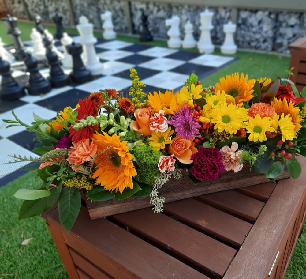 Royal Gratitude Centerpiece - Serving greens, beans, potatoes, tomatoes, you name it this holiday. Don't forget the seasonal color filled assortment of sunflowers, Gerbera, Mums, pom poms, assorted filler and greenery in a keepsake wooden planter  