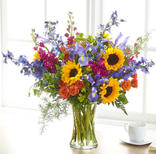 Rays Of Light Bouquet - Show your loved ones how much you care about them with a beautiful bouquet full of bright summer florals. Our Rays of Light Bouquet arrives with sunflowers, iris, stock and delphinium.