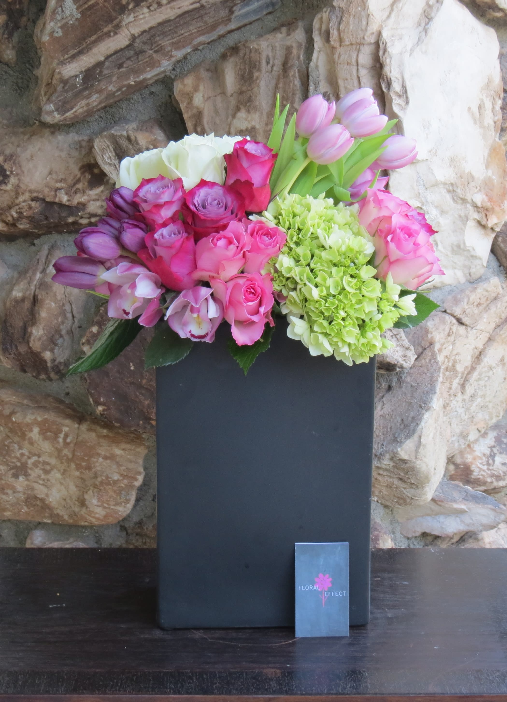 Rose and tulip garden Rose and tulip garden - Roses, tulips, cymbidiums arranged in a black ceramic vase.
