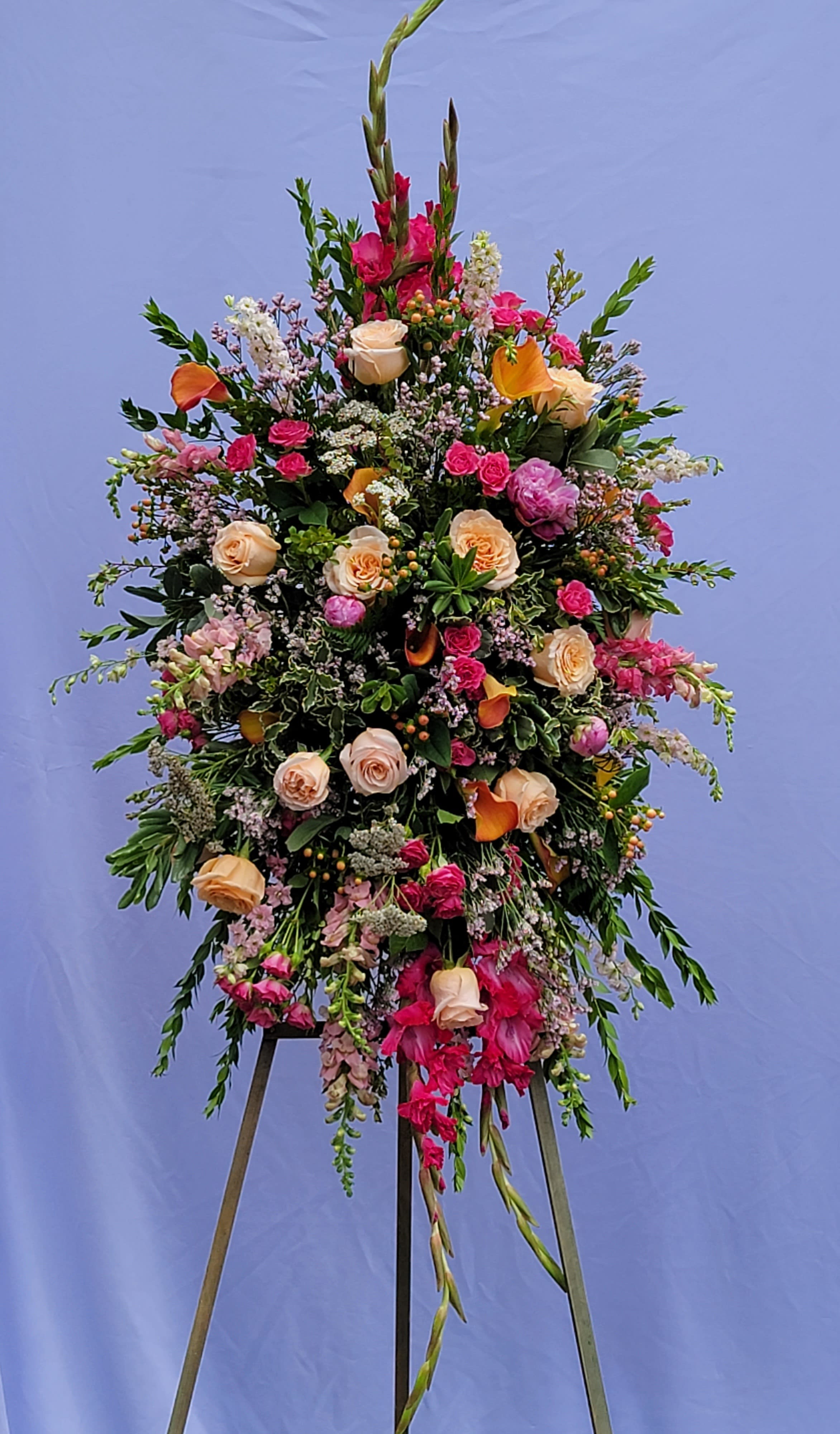Happy Memories Standing Spray Happy Memories Standing Spray - This bright and elegant sympathy piece features gladiolas, roses and more in a peach and pink tones.