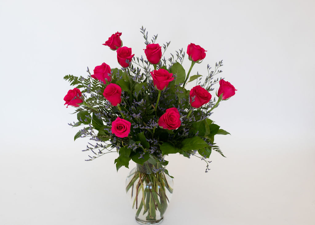 Classic Dozen in Hot Pink   - Beautiful and bright hot pink/magenta roses expertly arranged with beautiful greenery and mini accent flowers. Gorgeous roses that open perfectly every time. Approximately 20&quot; high and 10&quot; wide.