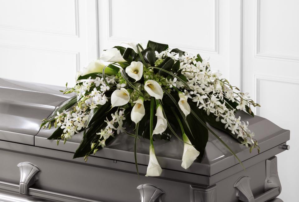 Angel Casket Spray - The FTD Angel Wings Casket Spray is an exceptionally gorgeous way  to bring peace and beauty to their final farewell service. White  Dendrobium orchids, white calla lilies, green hydrangea and a variety of  lush greens are artfully arranged to perfectly adorn the top of their  casket, offering the colors and ambience of grace and serenity.    0&quot;&quot;h x 36&quot;&quot;w &quot;