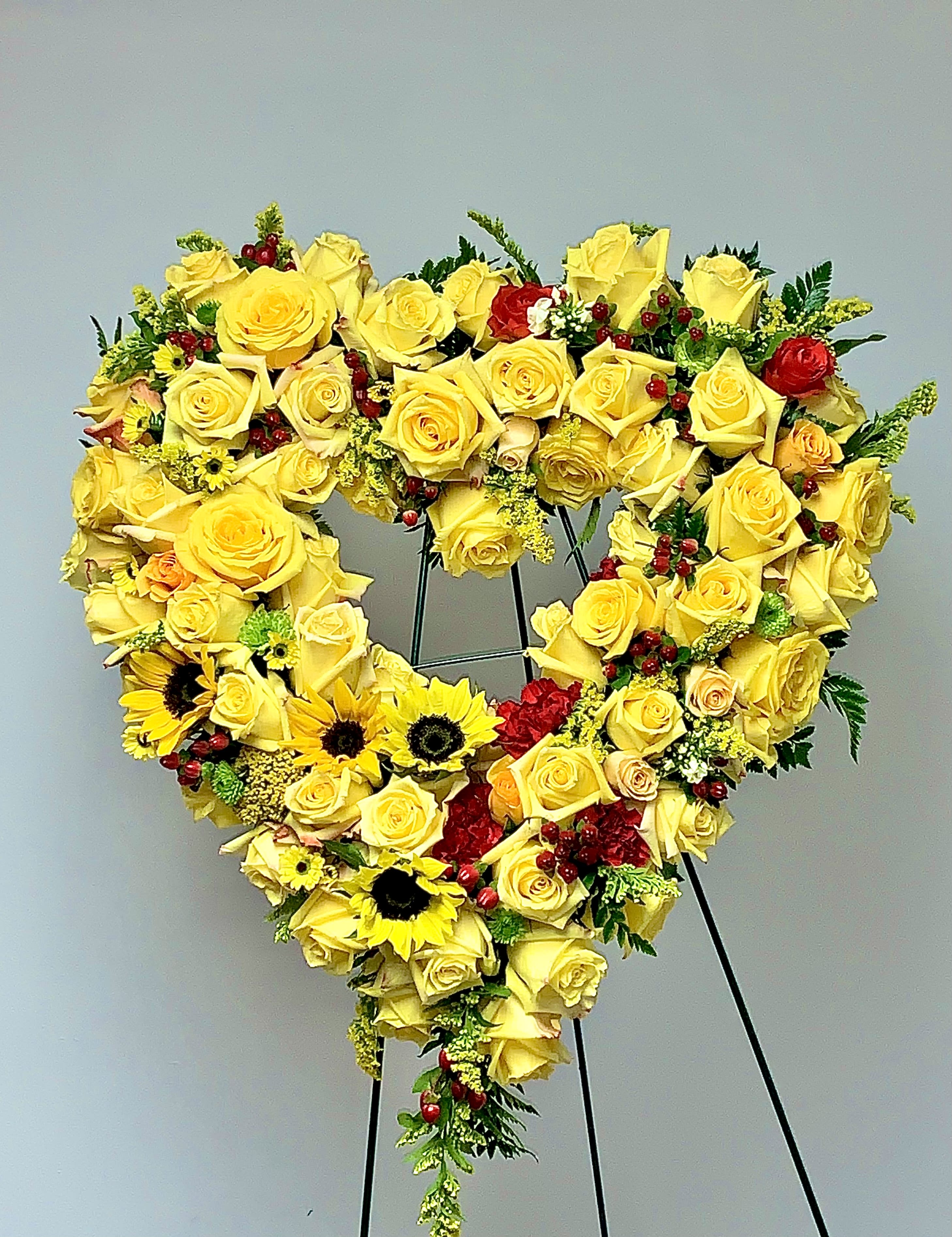 Sunshine Heart  - The forever sunshine heart is an array of beautiful bright yellow roses and sunflowers. Your beloved ones memory will forever remain shining through.