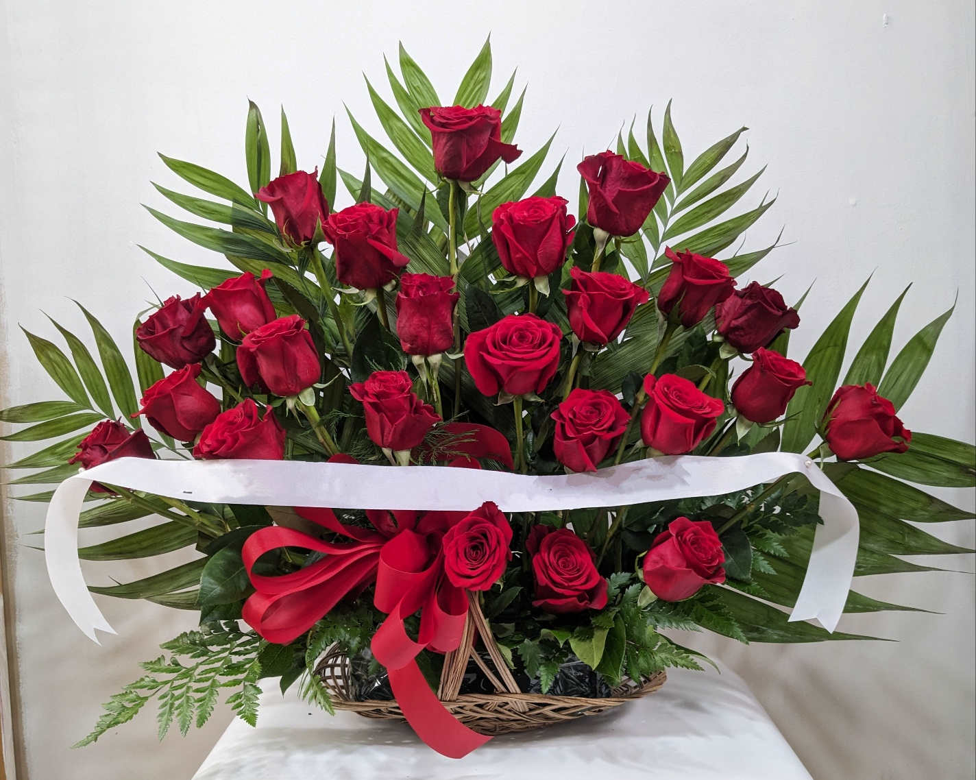 Forever Love fireside basket - Send a message of sympathy, love and hope with this basket of red roses. Our florists create this special sympathy arrangement in a fireside basket with two dozen premium long-stem roses accented with crisp greenery.  An additional fee is charged for Ribbon Approximate Dimensions: 28&quot;D x 30&quot;H