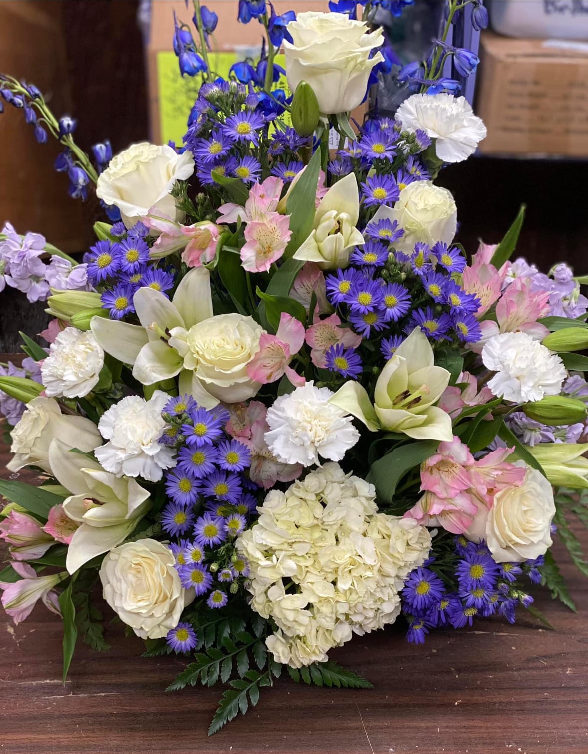 White Lavender  Bouguet -  Orient This dramatic arrangement includes lavender roses, lavender stock, lavender cushion, hydrangea spray chrysanthemums, lavender limonium, oregonia and lemon leaf.
