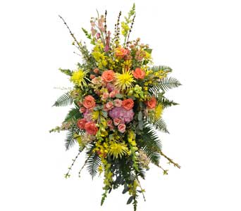 K613  Easel Spray (sample 3) - A vibrant assortment of colorful roses, hydrangea and orchids are arranged in this thoughtful spray. Please ask one of our sales associates for alternate colors and sizes.