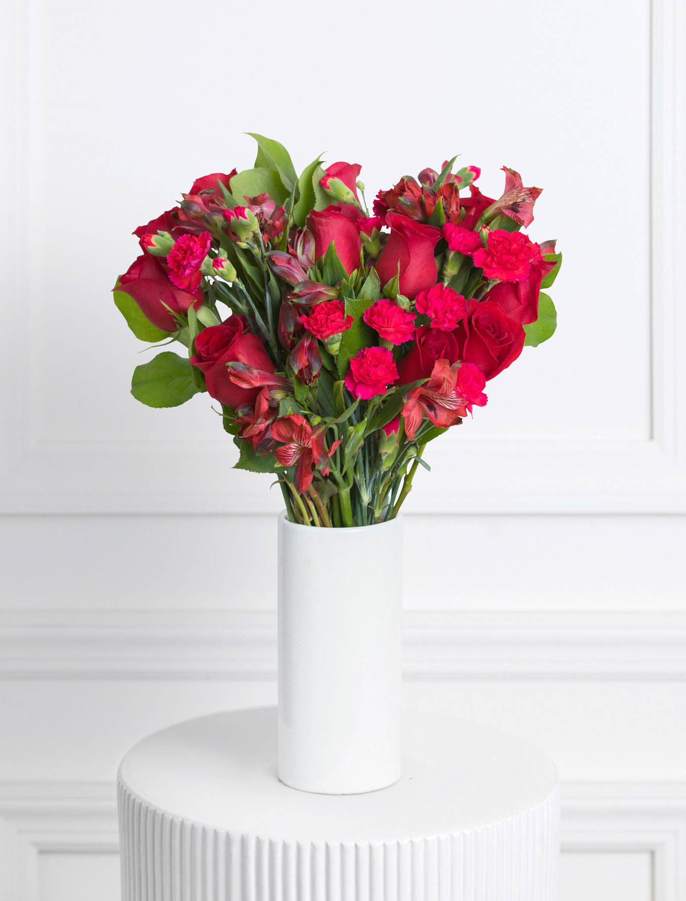 Andrea - Romantic and sweet all at once - our Andrea bouquet features an ombre of bright reds. Including romantic Freedom roses, lush red alstroemeria, and bright spray carnations, this bouquet sends a loving message to each recipient.