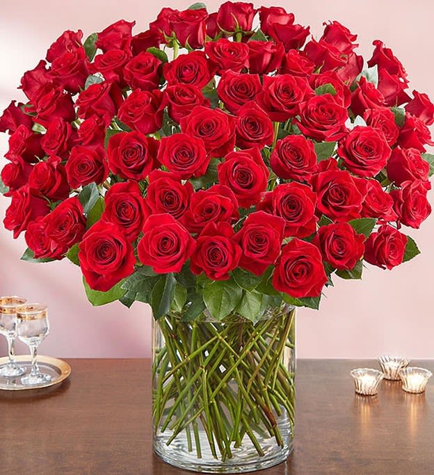 100 Premium Long Stem Red Roses - Wow the one you love like never before with 100 stunning long stem red roses! Our spectacular arrangement is artistically designed by our expert floral artisans with an abundant array of dazzling red blooms and lush greenery inside a classic cylinder vase. Standing over 2 feet tall, this luxurious surprise is personally hand-delivered for a grand romantic gesture she’ll remember always.