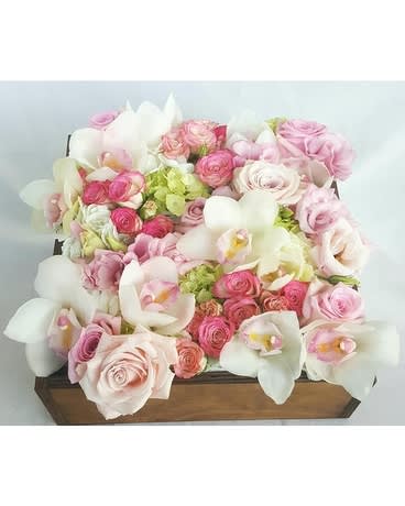 Garden of Roses - Capture the essence of delicate beauty with this enchanting boxed arrangement from Dave's Flowers, your local Los Angeles florist. Our &quot;Garden of Roses&quot; is a soft-spoken yet stunning masterpiece, perfect for any occasion where you want to express tenderness, joy, and a touch of romance.  Imagine: Blush-hued pastel pink roses: Their velvety petals unfurl like whispers of love, symbolizing affection, admiration, and new beginnings. Luscious green hydrangeas: A verdant embrace, adding depth and freshness, representing growth, abundance, and heartfelt gratitude. Elegantly poised white and pink dendrobium orchids: Their graceful arches echo with sophistication, embodying purity, innocence, and a touch of exotic splendor. All nestled in a charming wooden box, handcrafted with passion by our Los Angeles-based floral experts. This exquisite arrangement brings the vibrancy of a spring garden indoors, brightening any space and captivating hearts with its delicate charm.  Perfect for: Birthday celebrations Anniversary surprises Just-because gestures of love and appreciation Adding a touch of elegance to your home décor Local delivery to impress clients or colleagues Order your &quot;Garden of Roses&quot; boxed arrangement today through our Flower Delivery in Los Angeles and experience the joy of fresh, locally-sourced flowers delivered straight to your door!