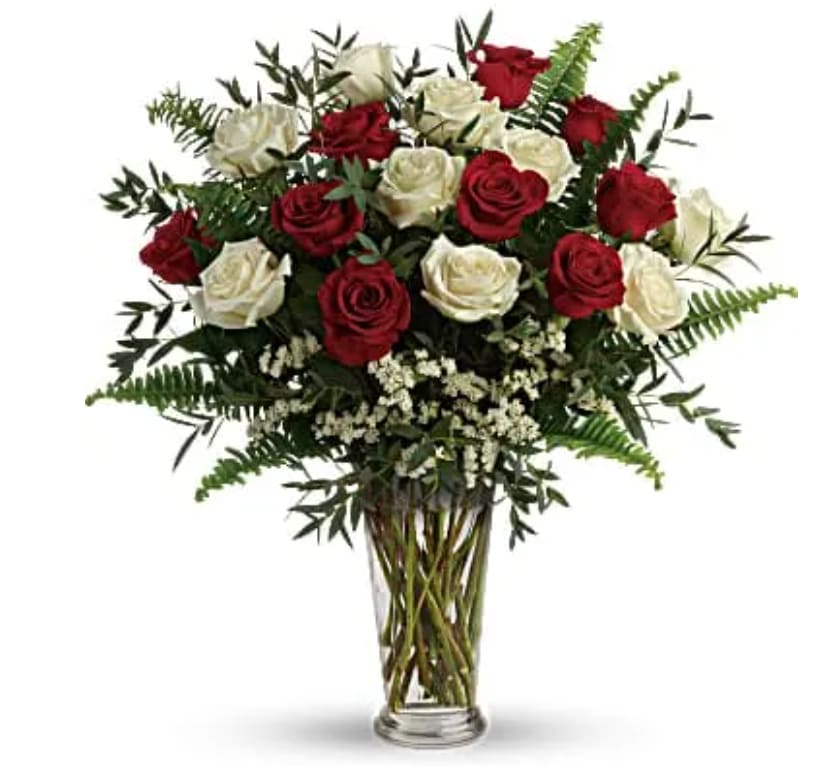 Yours Truly Bouquet - Make your special someone feel truly loved by surprising them with this extraordinary bouquet! A dozen and a half red and white roses are artfully arranged in a classic vase with delicate greens. This bouquet includes red roses, white roses, white sinuata statice, parvifolia eucalyptus, and sword fern. Delivered in a clear romanesque vase.