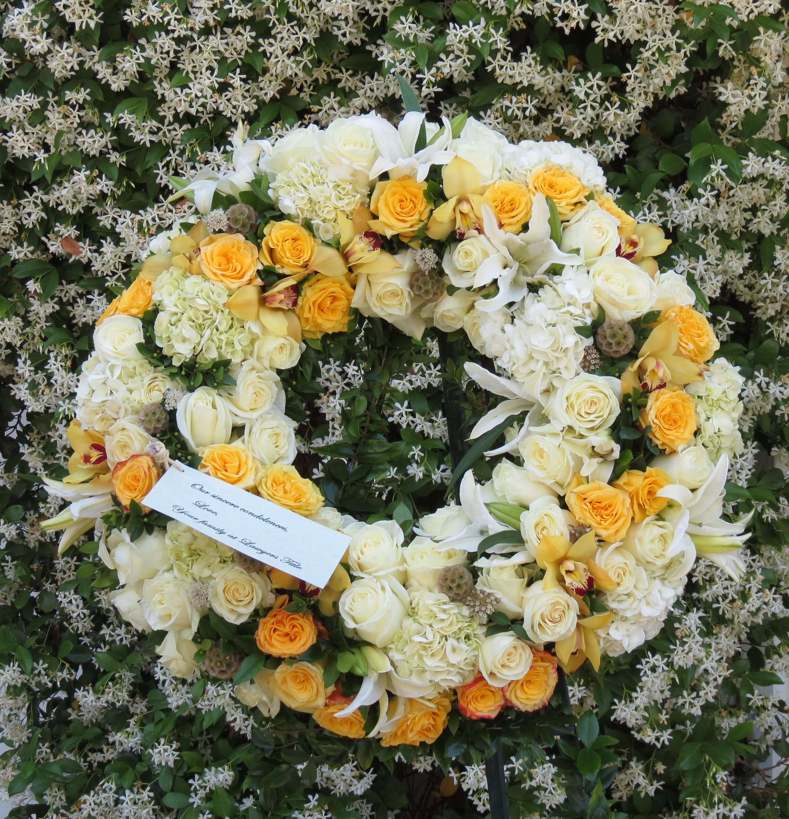 white and yellow standing wreath white and yellow standing wreath - Roses, hydrangeas, cymbidiums, and lilies arranged to create a beautiful wreath