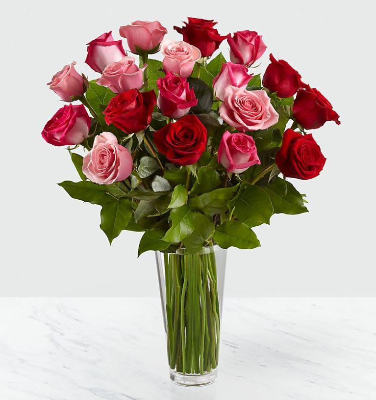 The True Romanc Rose Bouquet - VASE INCLUDED The True Romanc Rose Bouquet - VASE INCLUDED - The True Romance Rose Bouquet is the perfect expression of love and passion. A bright burst of color, this bouquet combines red, pink and fuchsia roses, accented with beautiful greens and seated in a clear glass vase, to create a truly romantic representation of your love. Comes in 12, 18 and 24 stems. Pictured is 18 stems