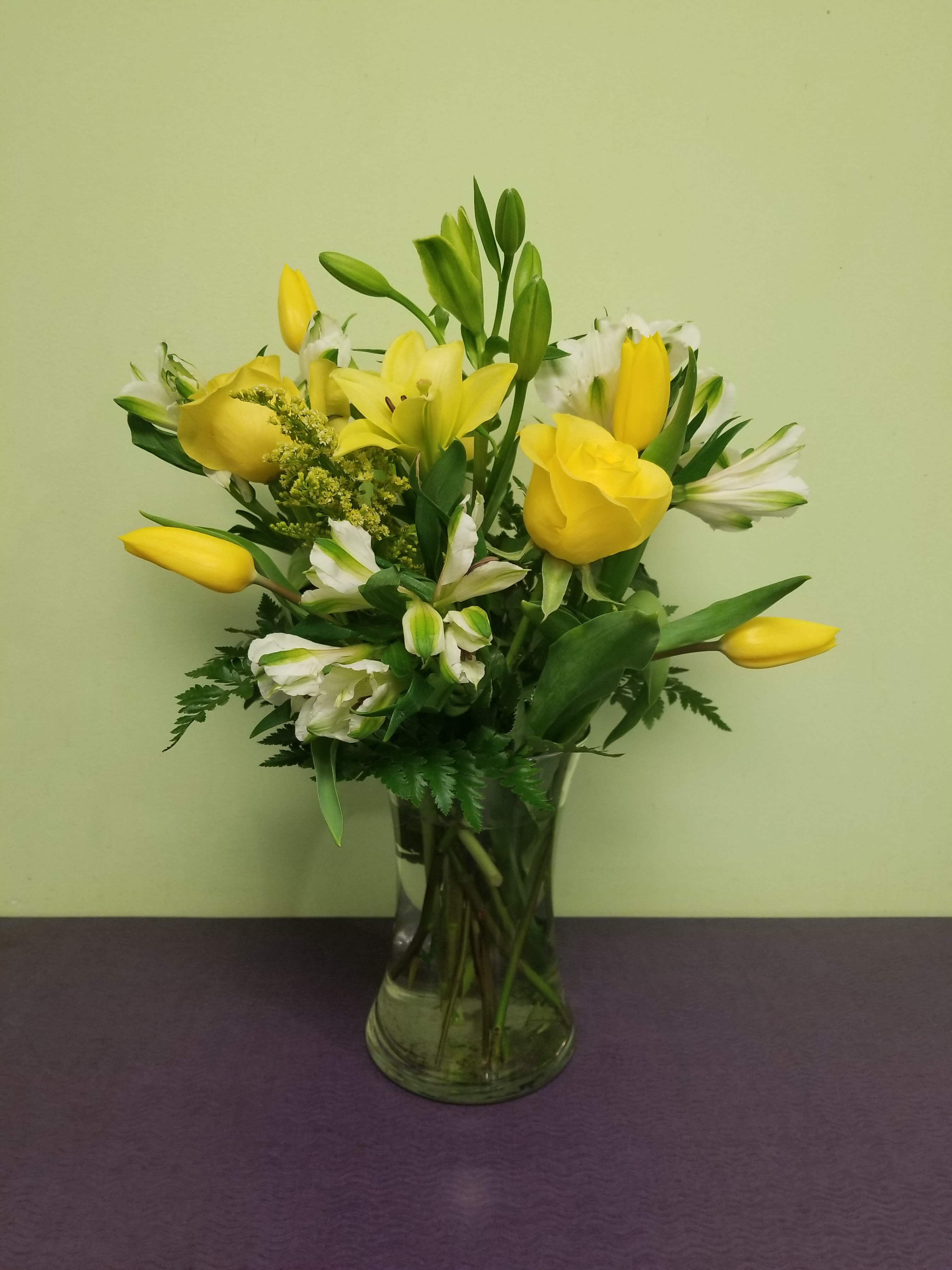Lemon Drop - Send that special person in your life this extra special arrangement. Light up their hearts with this bright and cheery arrangement. Includes their favorites like Lilly's, Tulips, Roses and more!