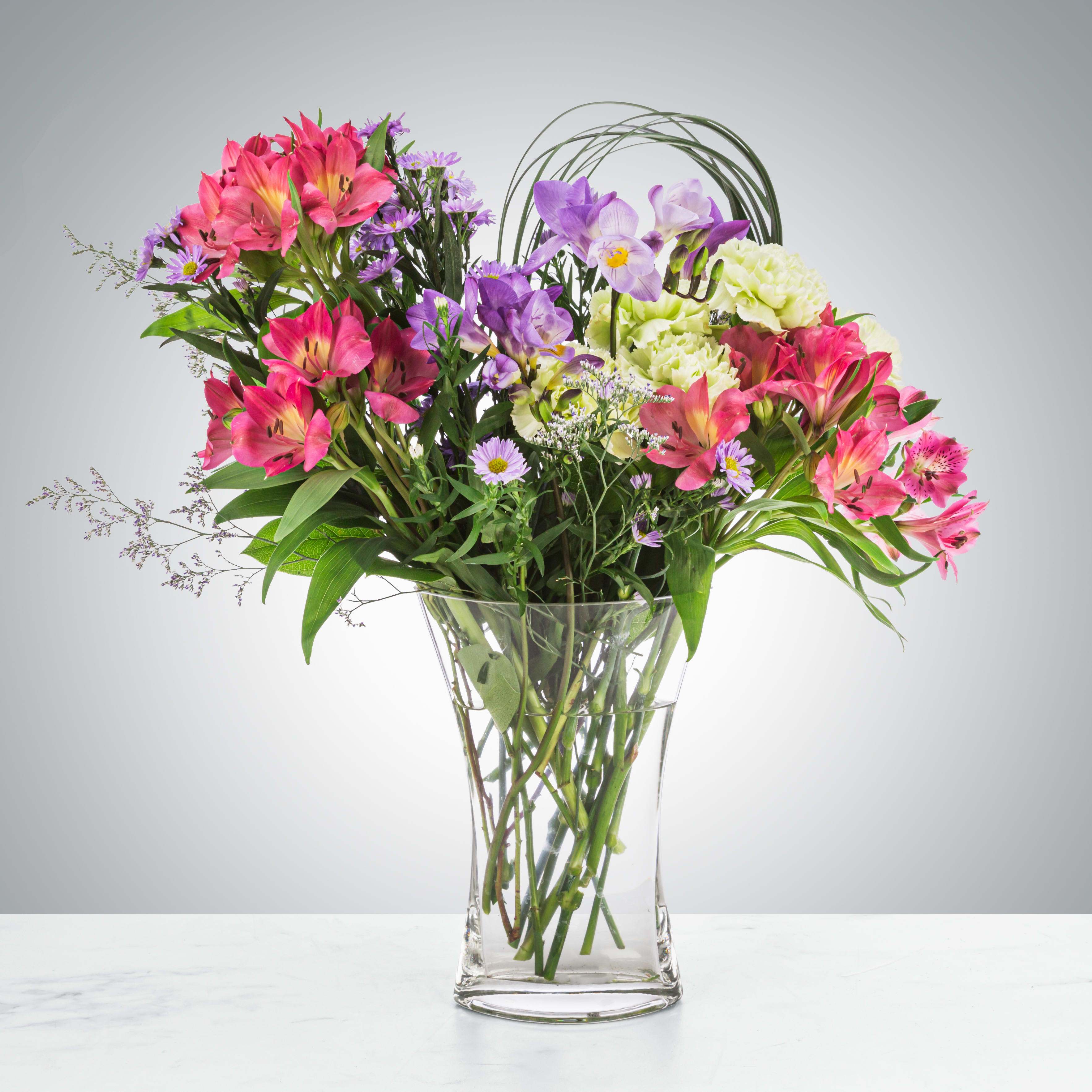 Wispy Fantasy Wispy Fantasy - This elegant arrangement features asters, freesia, alstroemeria, and more. Aster is the September birth flower and freesia symbolizes friendship making this a great option for fall birthdays or celebrating friendship day. Approximate Dimensions: 15"D x 15"H