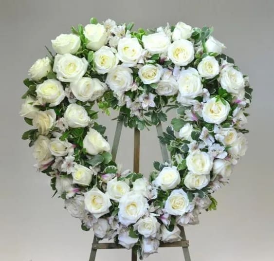 Serenity Heart Wreath - An elegant all white heart wreath made of premium roses and garden roses in memory of the beloved. *PICTURE SHOWN IS DELUXE  Standard: Approximately 20″ W x 21″ H Deluxe: Approximately 22″ W x 23″ H Premium: As pictured. Largest size for this design. Approximately 24″ W x 25″ H
