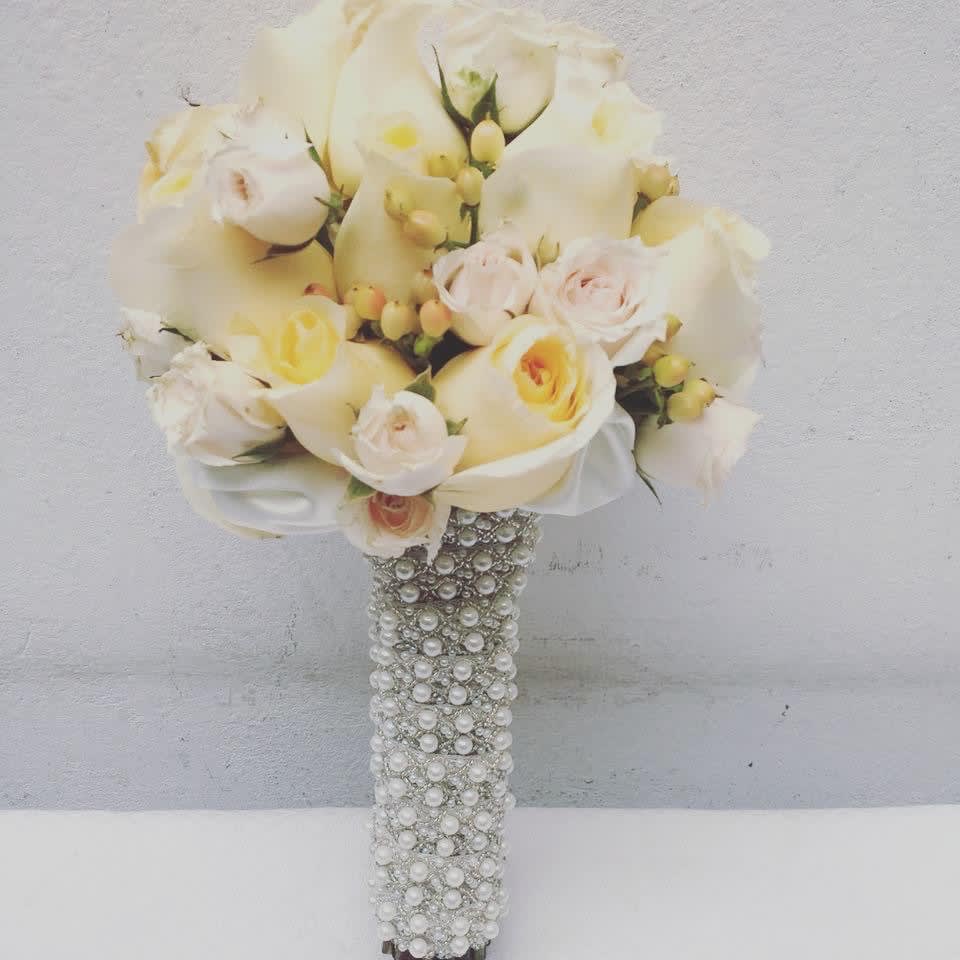 PARIS bridal Bouquet by The House of Flowers PARIS bridal Bouquet by The House of Flowers - An elegant bridal bouquet of white roses and baby roses hand-tied with delicate pearl ribbon. The perfect complement for a wedding.