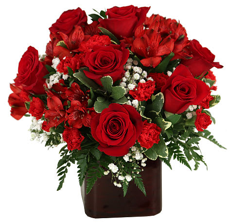 A Passion For Red - A dark red vase is arranged with luscious red blooms, including red roses, red alstroemerias and red miniature carnations. The abundance of red is accented with delicate white baby's breath, and assorted greenery. Go ahead and admit it - you love red!