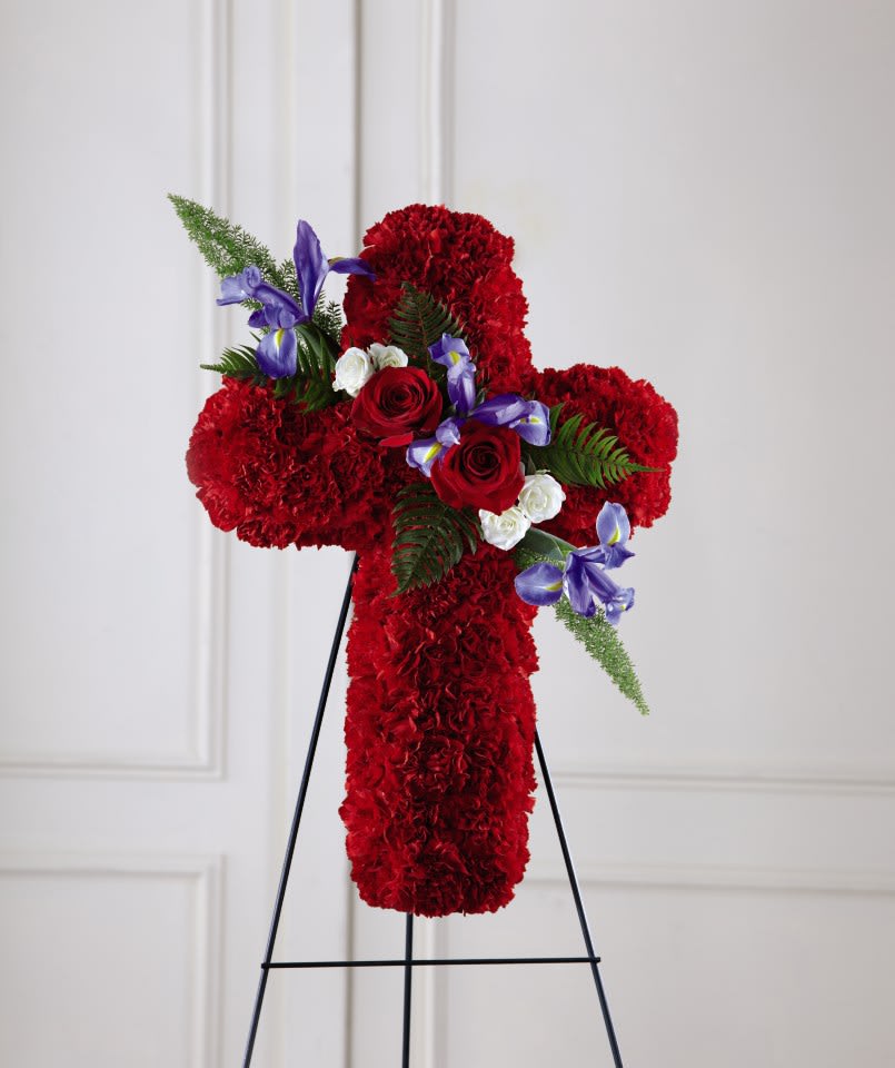 Faithful Hero™ Floral Cross  - For expressing your sympathies in a thoughtful manner, our Faithful Hero™ Floral Cross shares blessings to a loved one who devoted their life to patriotism. An array of rich carnations accents the textures of iris and roses to complete this hand delivered standing spray.  Details: o Cross is approximately 24&quot;H x 15&quot;W 