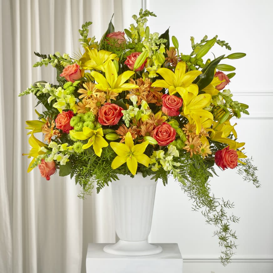 The Fall Sentiments™ Arrangement  - The bright yellows, bold oranges and vibrant greens in our Fall Sentiments™ Arrangement capture your heartfelt condolences. Each bloom offers warmth and sympathy to the people you care about as they grieve during this difficult time. This stunning arrangement arrives handcrafted and hand delivered by a local florist to any service or home.  Details:  o Arrangement is approximately 32&quot;H x 31&quot;W 