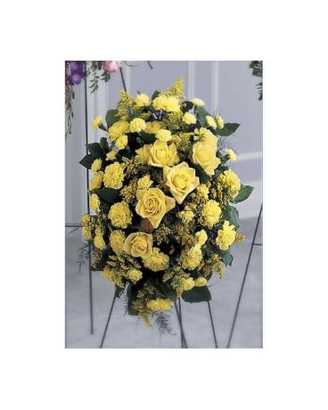 Glowing Tribute Glowing Tribute - Bright yellow hues catch the eye in this golden standing spray. Yellow roses, carnations and mini carnations, and solidago, are arranged with salal and feathery plumosa. Flowers may be susbtituted depending on availability. FCS11-3796