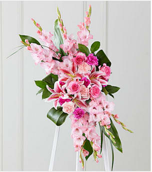 Sweet Farewell™ Standing Spray - When your feelings of loss and sorrow compel you to make a grand gesture of sympathy, this dramatic, standing arrangement is a lovely way to convey your sincerest condolences. This extraordinary composition of pink blooms and lush greens handcrafted by an FTD artisan florist includes roses, carnations, gladiolus and Stargazer lilies set among lush, contrasting greenery. Made to be displayed on an easel, it makes an appropriate choice for a wake, funeral or graveside service, sure to be much appreciated and long remembered.  Your purchase includes a complimentary personalized gift message.