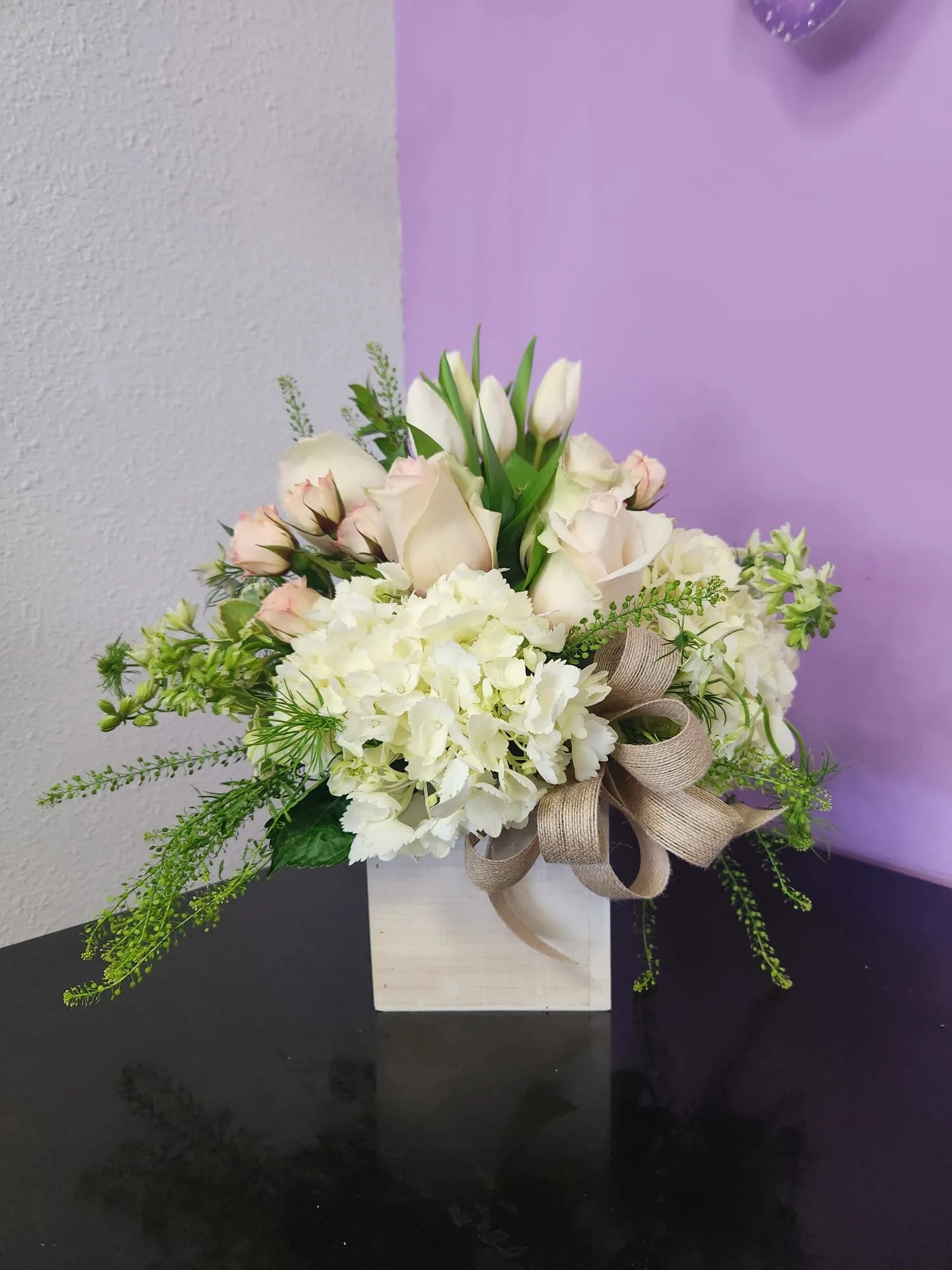 Heartfelt Wishes - This sophisticated arrangement features an elegant mix of white and cream blooms, including roses, tulips, and hydrangeas, arranged in a sleek box. The perfect gift to express love and appreciation on Valentine's Day. This arrangement offers a neutral and timeless expression of love and is sure to make a lasting impression.  *Also available with red roses