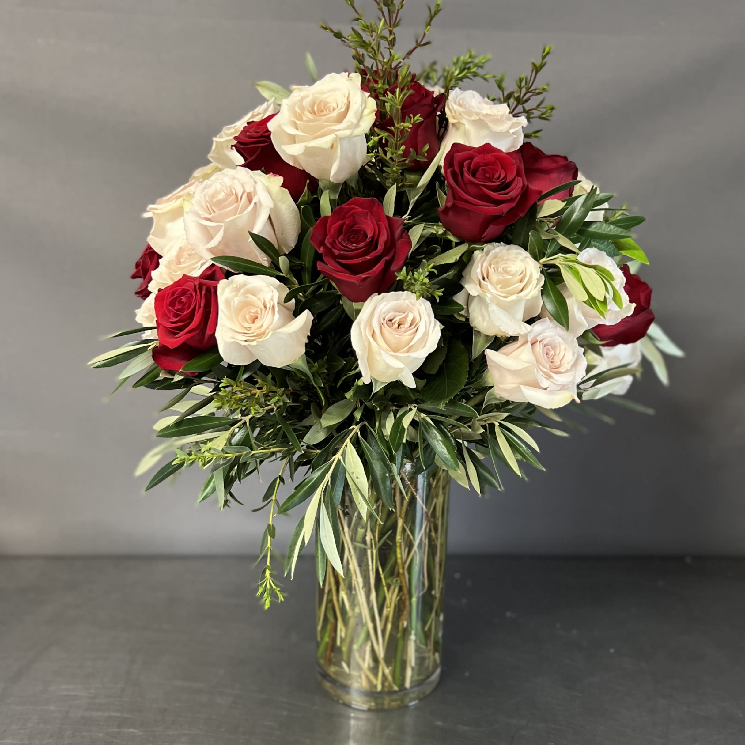 GEORGEOUS - Imported Ecuadorian roses arranged together in a glass vase.