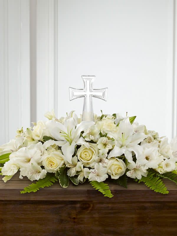 White Purity and peace Casket Spray - Gorgeous white lilies, roses, alstromerias and more create a beautiful crescent shaped casket spray. It is a simply stunning way to honor the deceased. 