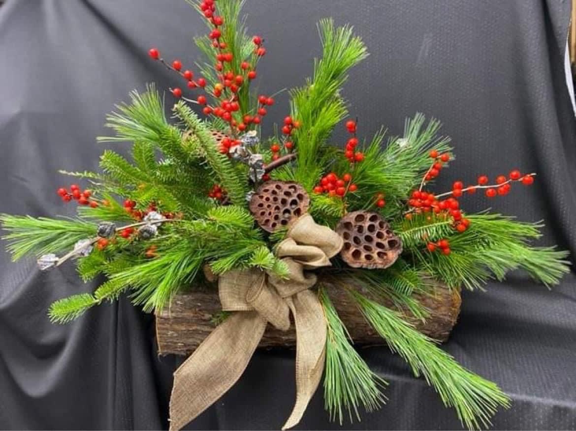 Woodland - winter centerpiece made up of seasonal greens Berries, and pods. 