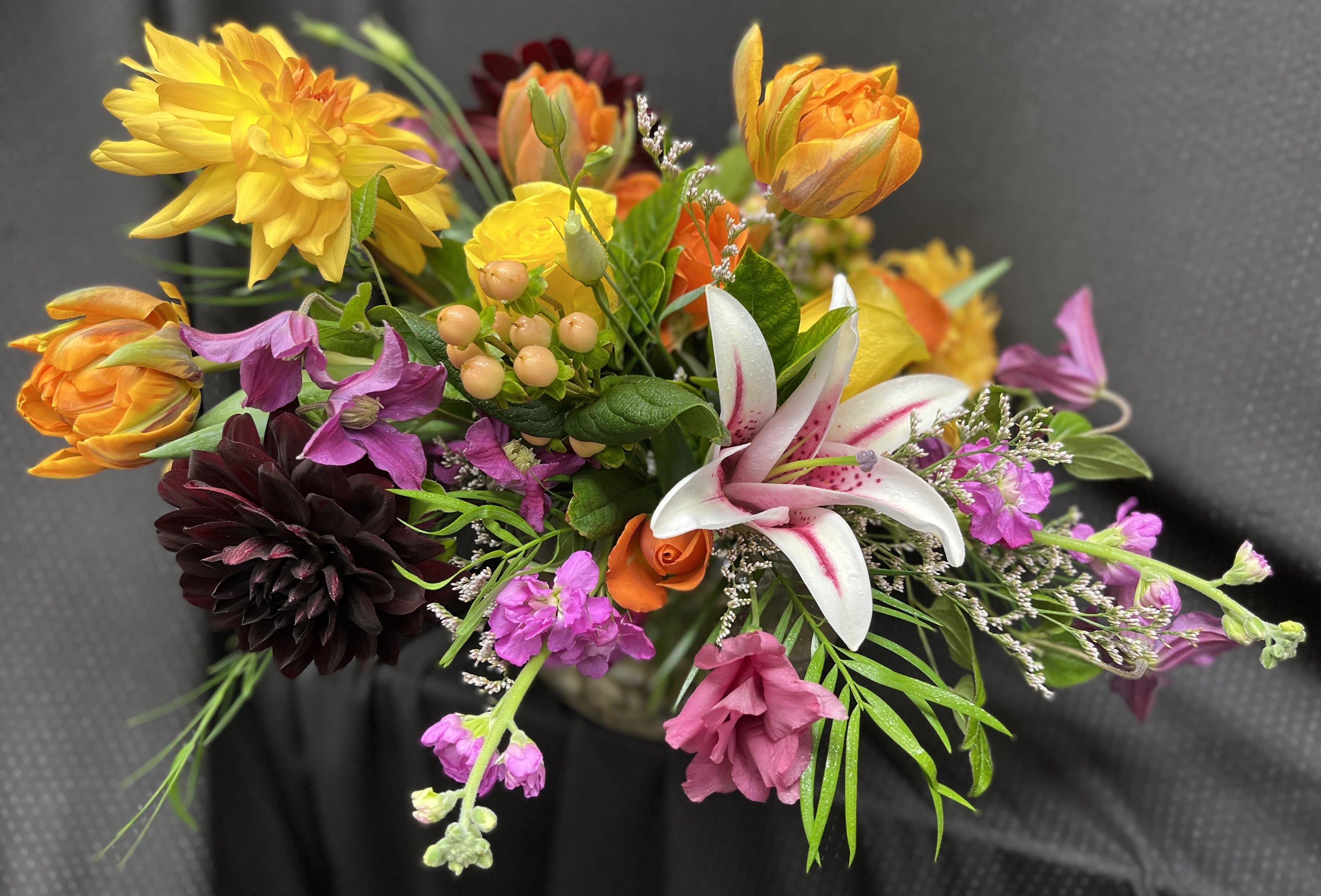 Sunrise - Vase arrangement made up with tulips, dahlias, lily, and stock. 