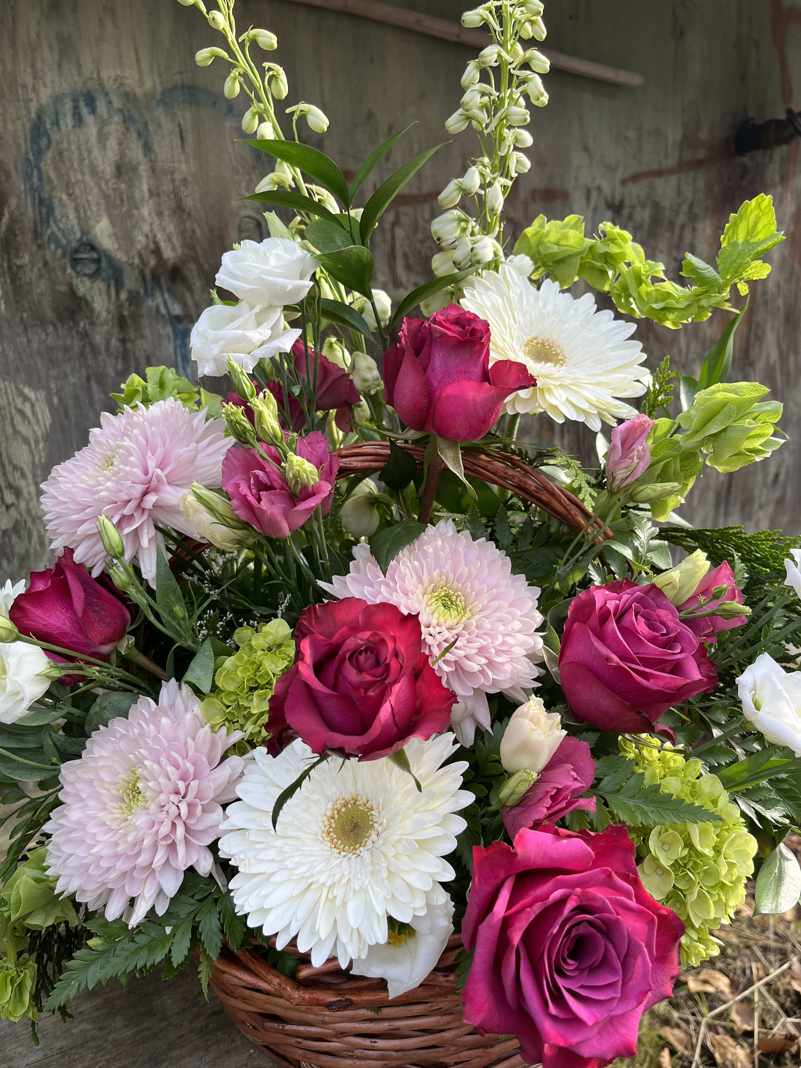 In memory of Basket - Basket arrangement made up or Roses, mums, delphinium, and mixed greens. 