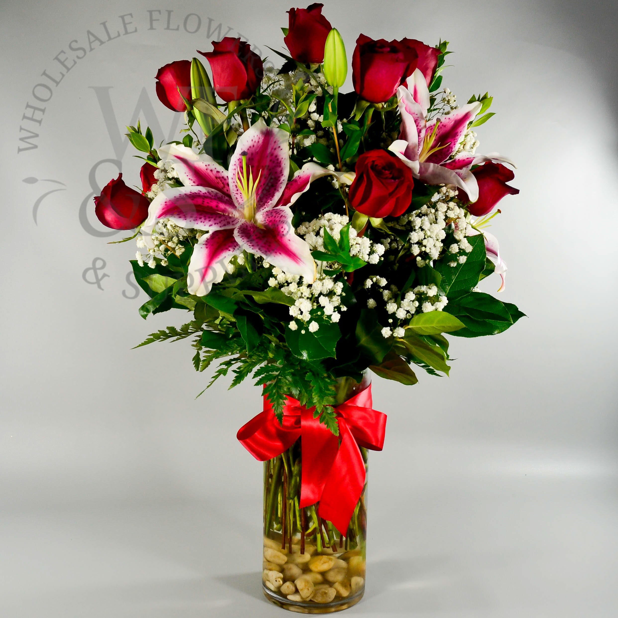 RED ROMANCE - The RED ROMANCE is one of our popular selection.   A dozen red roses design in tall glass cylinder with Oriental pink lilies,and accent with babies breath, greenery and red bow!! Approx. size: 22&quot; tall by 12&quot; wide #VCY0512/84012C