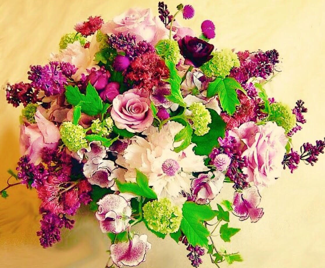 Lavender Twilight Lavender Twilight - Arrangement with pink roses and a mixture of pink and green flowers.