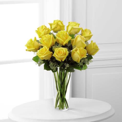 FTD Yellow Rose Bouquet - Sunny yellow roses are a cheery and wonderful gift. Celebrate a  birthday, anniversary, graduation or any occasion with this lively  bouquet arranged with seeded eucalyptus in a clear glass vase.  19h x 15w
