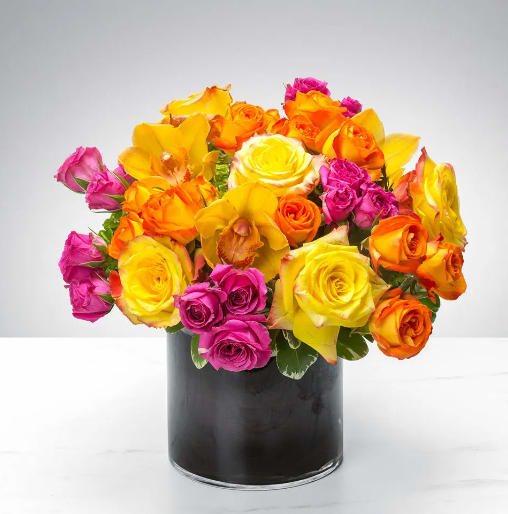 Bright Abundance by BloomNation™ Bright Abundance by BloomNation™ - This cylindrical vase of flowers is kind of like a time capsule, if time were made of flowers. What a wonderful “time” that would be. In the season of changing plants, leaves, and flowers, this cylinder of bright abundance reminds us of the beauty that comes with the changing of the seasons. Spoiler alert: that’s a lot of beauty.