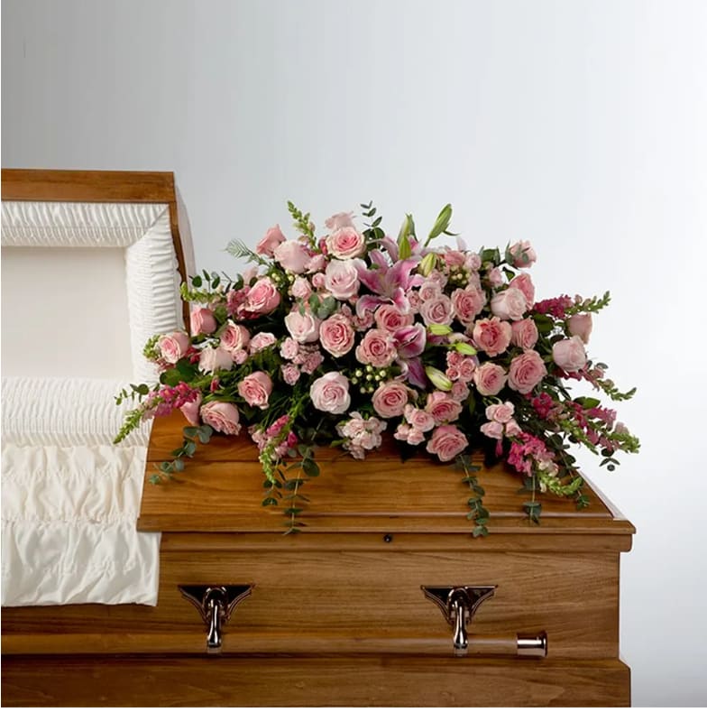 Tender Heart by BloomNation™ Tender Heart by BloomNation™ - Roses, lilies, and more come together for a blushing pink half casket spray. Sized to fit both open and closed caskets.