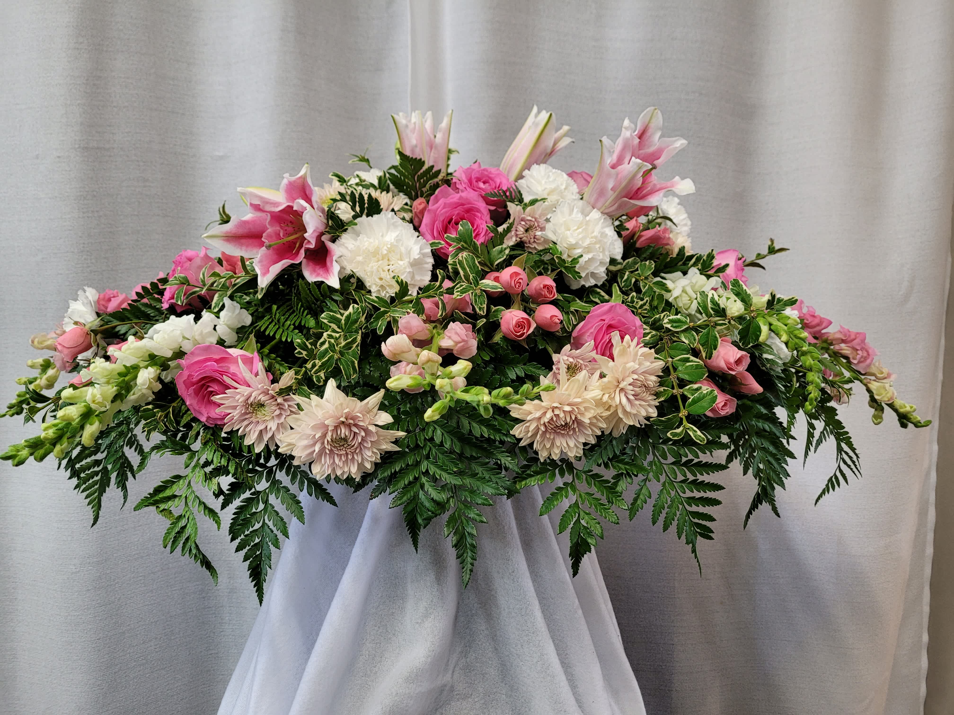 Pink + White Casket Spray - This is a traditionally shaped oval casket spray of pink and white flowers. It is 36&quot; in length.