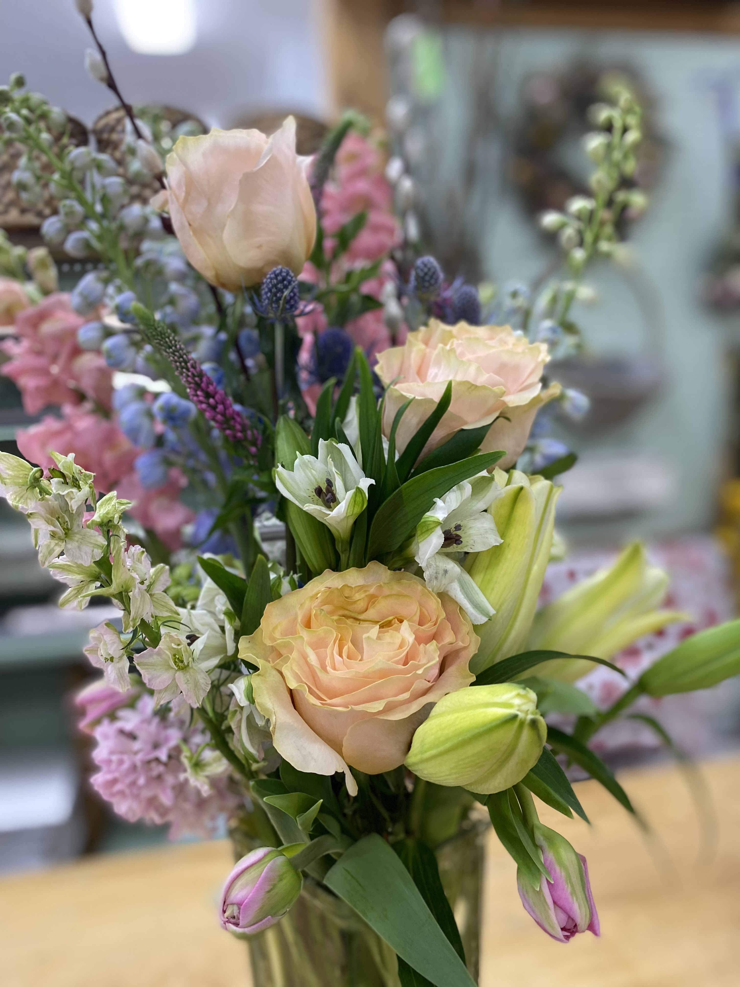Touch of Rose - Tall vase arrangement with roses, lilies, larkspur, tulips, and alstroemeria in a glass vase. 